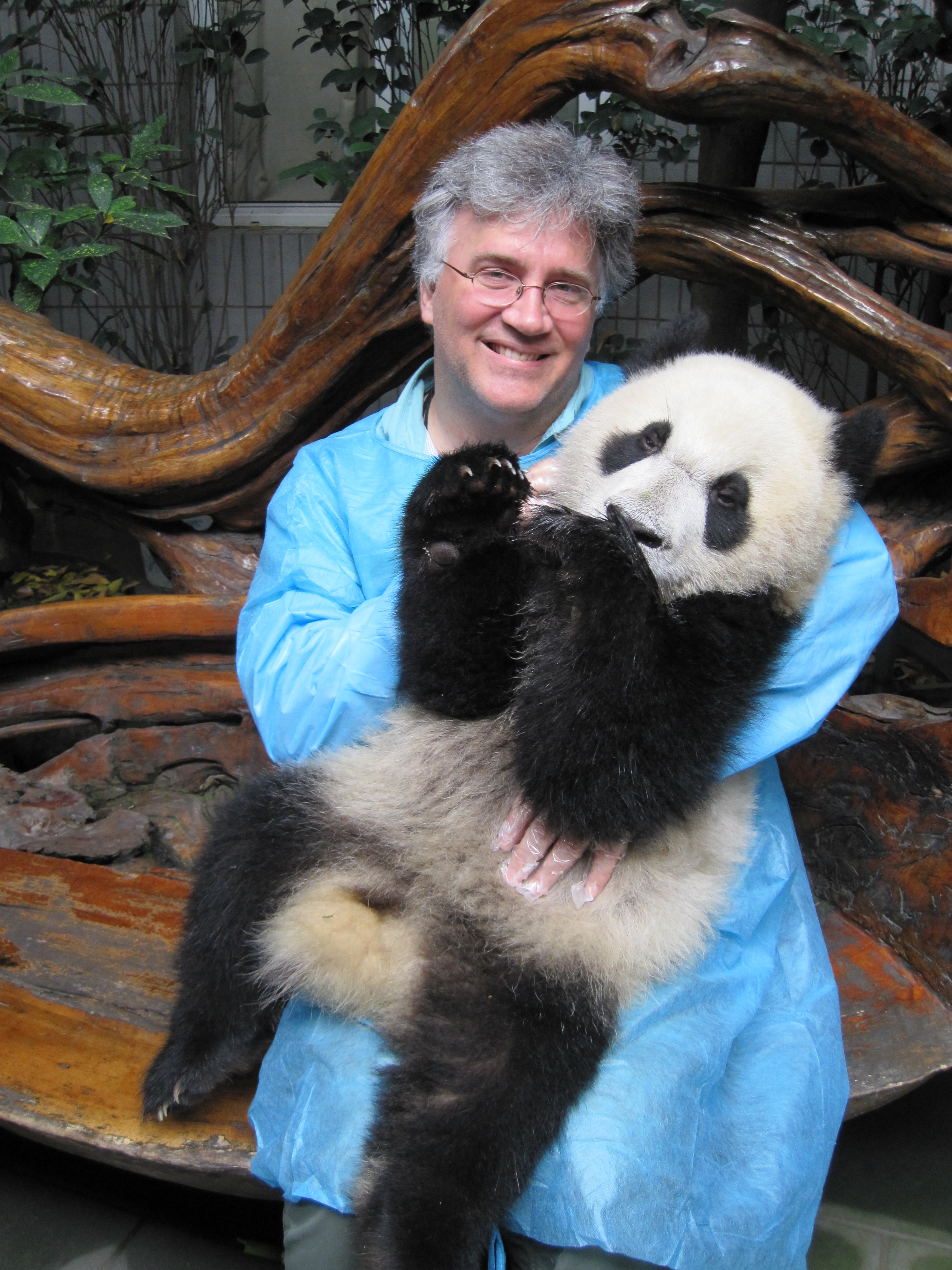 Mark Lewendowski holding a panda cub.
