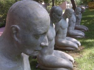 Photo of statues kneeling in park