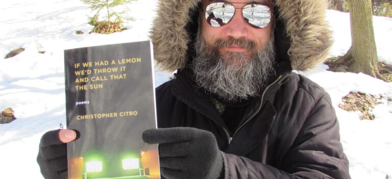 Christopher holding If We Had a Lemon in the snow