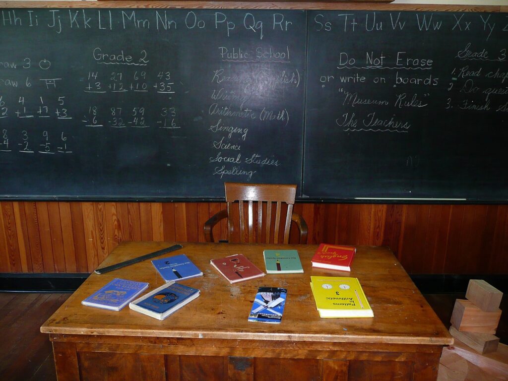A decorative picture showing a teacher's desk cluttered with books.